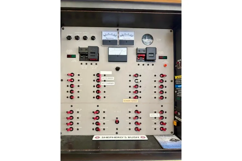 Slide: The Image of Electrical control panel of a 1997 Maxum 4100 SCA boat, featuring switches and gauges. - 42