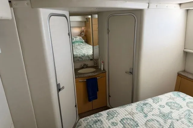Slide: The Image of Interior of 1997 Maxum 4100 SCA yacht with bed, bathroom, and mirror. - 29