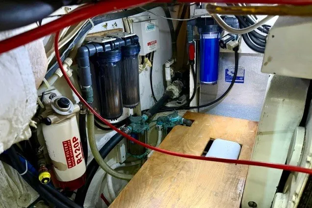 Slide: The Image of Engine room of a 1997 Maxum 4100 SCA boat, featuring filters and mechanical components. - 34