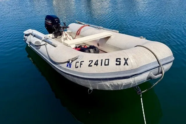 Slide: The Image of A 1997 Maxum 4100 SCA inflatable boat moored on calm water. - 44