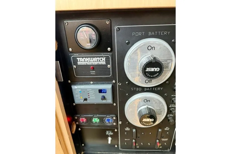 Slide: The Image of Control panel of a 1997 Maxum 4100 SCA boat with battery switches and gauges. - 41