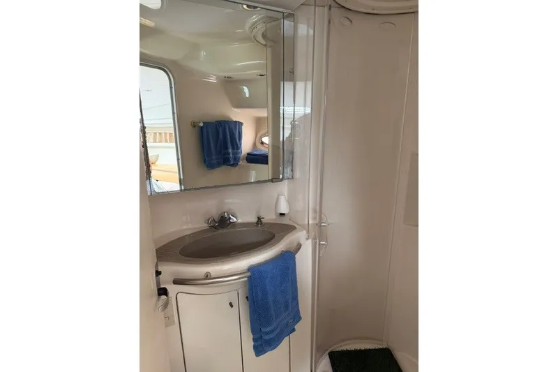 Slide: The Image of Bathroom interior of 1997 Maxum 4100 SCA yacht with sink and mirror. - 25