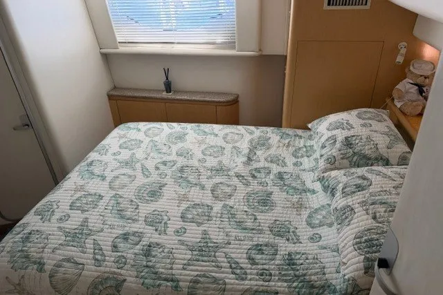 Slide: The Image of Cozy bedroom in 1997 Maxum 4100 SCA yacht with seashell-patterned bedding. - 30