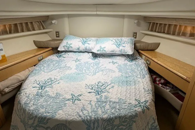 Slide: The Image of Cozy bedroom in 1997 Maxum 4100 SCA yacht with nautical-themed bedding. - 33