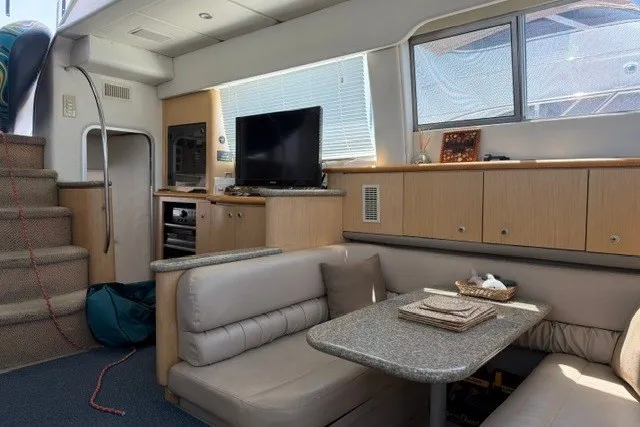 Slide: The Image of Interior of 1997 Maxum 4100 SCA yacht with cozy seating, TV, and modern amenities. - 20