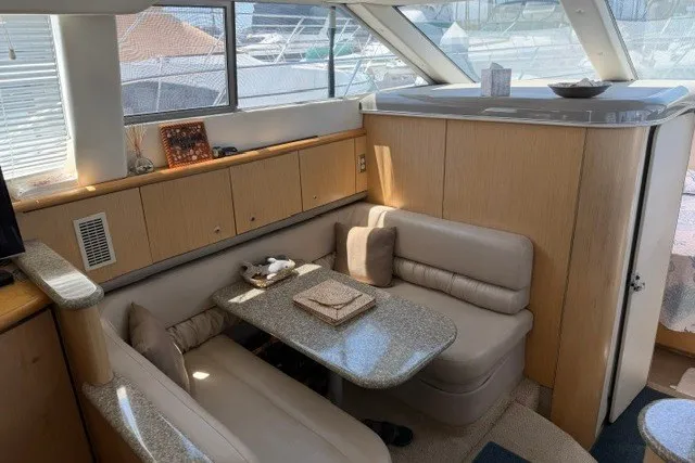 Slide: The Image of Luxurious interior of 1997 Maxum 4100 SCA yacht with cozy seating and elegant decor. - 26