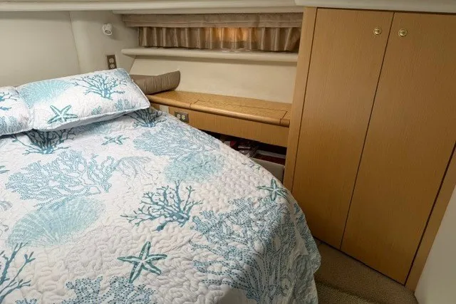 Slide: The Image of Cozy bedroom in 1997 Maxum 4100 SCA yacht with nautical-themed bedding. - 31