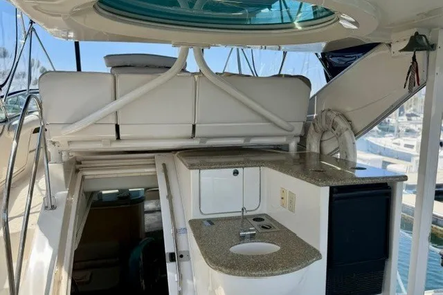 Slide: The Image of 1997 Maxum 4100 SCA yacht interior with kitchenette and seating area. - 13