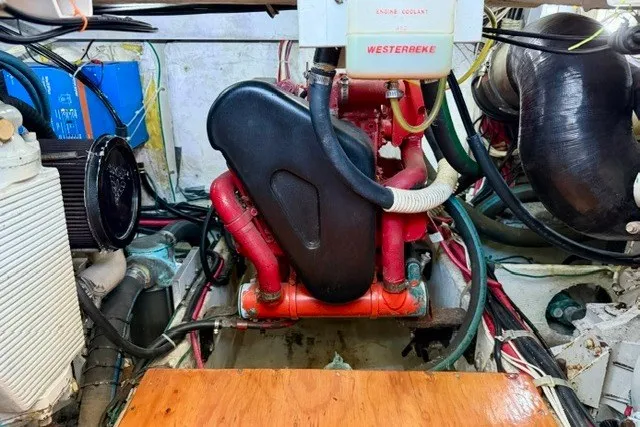 Slide: The Image of Engine room of 1997 Maxum 4100 SCA with Westerbeke generator and red components. - 38