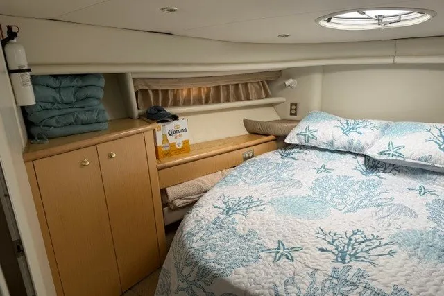 Slide: The Image of Cozy cabin interior of 1997 Maxum 4100 SCA yacht with nautical-themed bedding. - 32