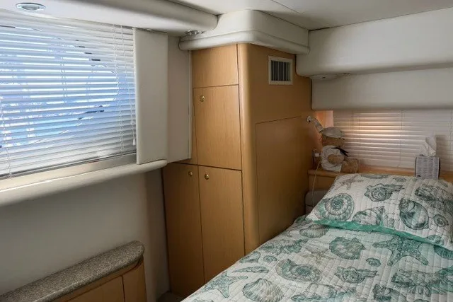 Slide: The Image of Cozy cabin interior of 1997 Maxum 4100 SCA yacht with bed and storage. - 27