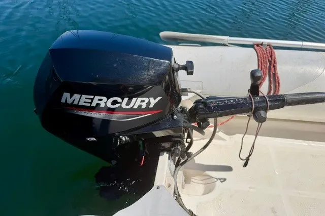 Slide: The Image of Mercury outboard motor on a 1997 Maxum 4100 SCA boat, docked on calm water. - 46