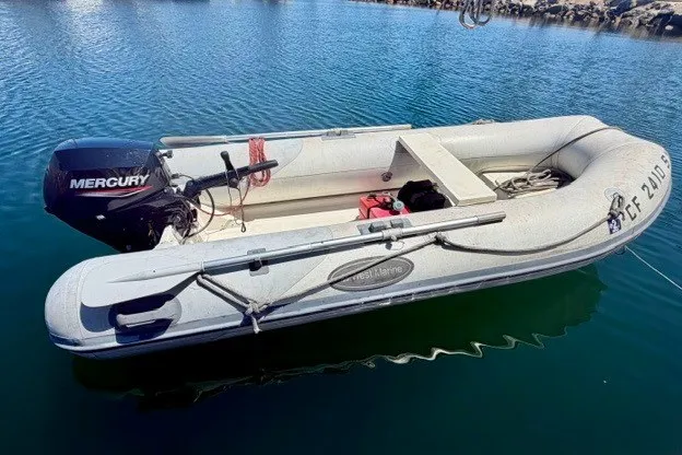 Slide: The Image of Inflatable boat with Mercury outboard motor on calm water. - 45
