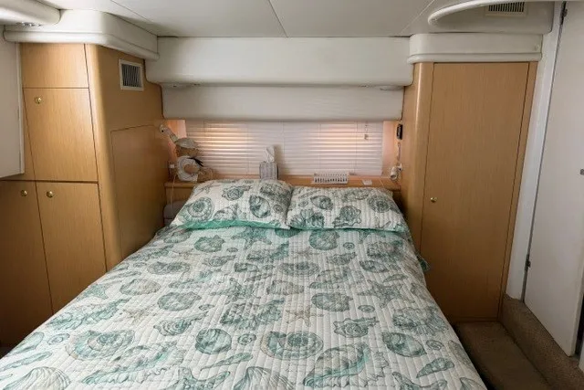 Slide: The Image of Cozy bedroom in 1997 Maxum 4100 SCA yacht with seashell-patterned bedding. - 28