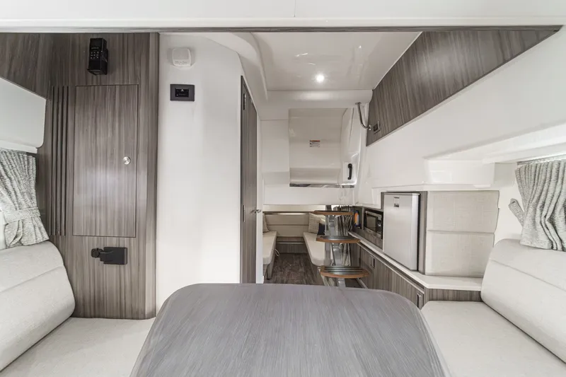 Slide: The Image of Interior of a 2025 Sea Ray 320 Sundancer DA Coupe with modern furnishings and sleek finishes. - 23