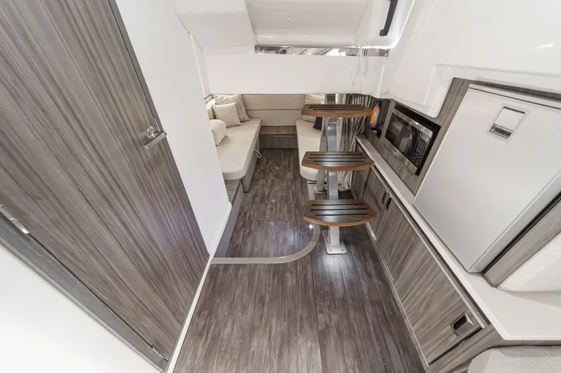 Slide: The Image of Interior of a Sea Ray 320 Sundancer DA Coupe with modern wood flooring and sleek stairs. - 24