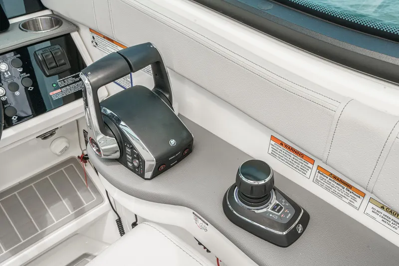 Slide: The Image of The image shows the helm of a Sea Ray 320 Sundancer DA Coupe with modern controls. - 14