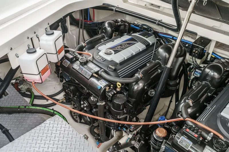 Slide: The Image of The engine room of a 2025 Sea Ray 320 Sundancer DA Coupe features a 6.2-liter engine. - 36