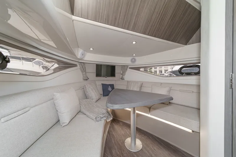Slide: The Image of Interior of a 2025 Sea Ray 320 Sundancer DA Coupe with elegant seating area and table. - 21