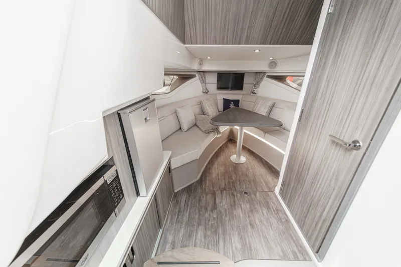 Slide: The Image of Interior of a 2025 Sea Ray 320 Sundancer DA Coupe with elegant seating area and table. - 20