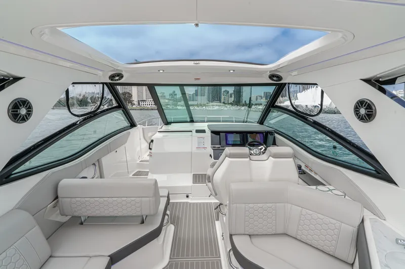 Slide: The Image of The image shows the cockpit of a 2025 Sea Ray 320 Sundancer DA Coupe with luxurious seating and modern electronics. - 7