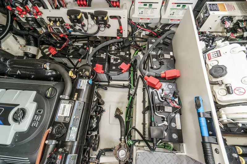 Slide: The Image of The engine room of a 2025 Sea Ray 320 Sundancer DA Coupe shows engines and wiring. - 39