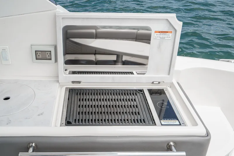 Slide: The Image of A built-in grill on a boat with a view of the water. - 6