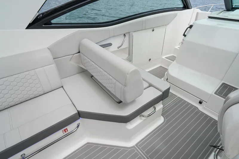 Slide: The Image of The image shows the cockpit of a 2025 Sea Ray 320 Sundancer DA Coupe with sleek seating. - 9