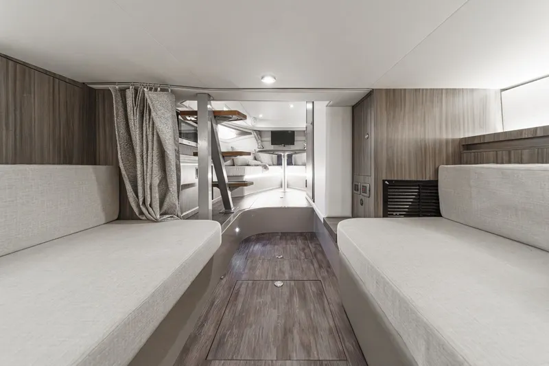 Slide: The Image of Interior of a 2025 Sea Ray 320 Sundancer DA Coupe with modern seating and wood flooring. - 28