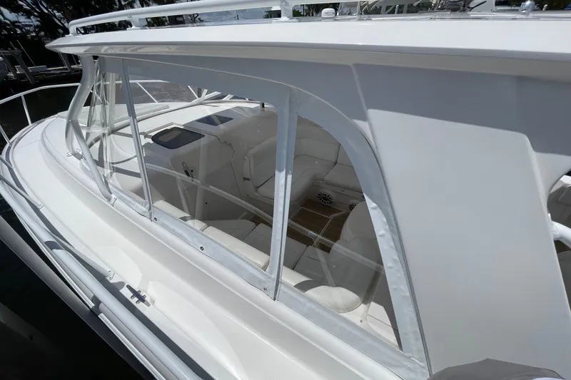 Slide: The Image of 2010 Intrepid 390 Sport Yacht with sleek white exterior and spacious interior seating. - 29