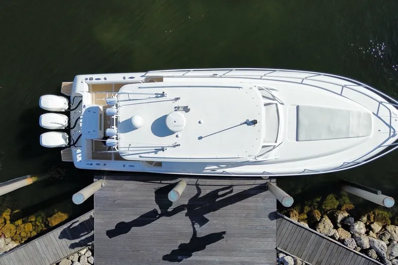 Slide: The Image of Overhead view of a 2010 Intrepid 390 Sport Yacht docked at a wooden pier. - 44