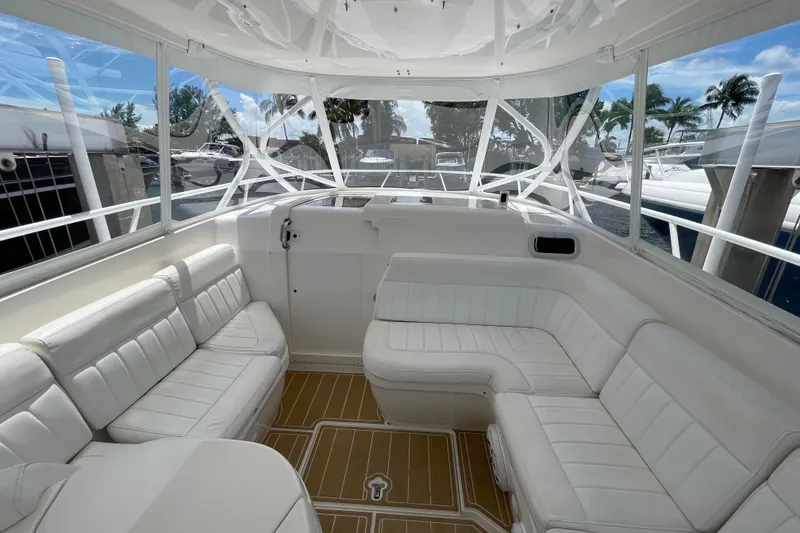 Slide: The Image of Luxurious interior of a 2010 Intrepid 390 Sport Yacht with white seating and panoramic windows. - 36