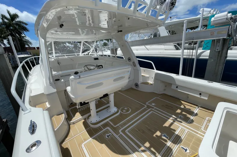Slide: The Image of 2010 Intrepid 390 Sport Yacht with spacious deck and modern helm station. - 24