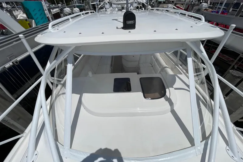 Slide: The Image of 2010 Intrepid 390 Sport Yacht with sleek white design and spacious seating area. - 16