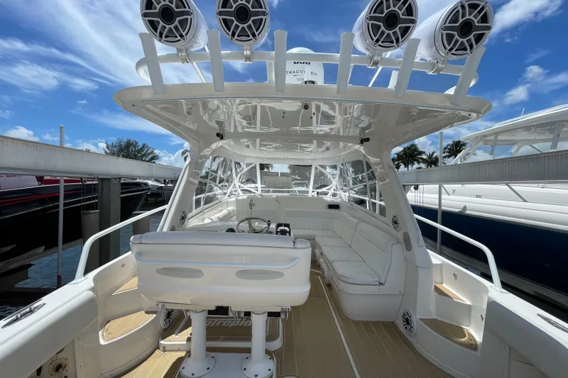 Slide: The Image of 2010 Intrepid 390 Sport Yacht interior with white seating and advanced audio system. - 22