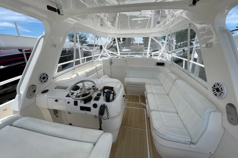 Slide: The Image of Luxurious interior of a 2010 Intrepid 390 Sport Yacht with white seating and helm. - 33