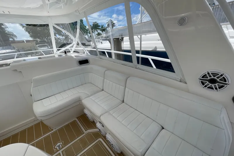 Slide: The Image of Luxurious white seating area on a 2010 Intrepid 390 Sport Yacht, with scenic marina views. - 34