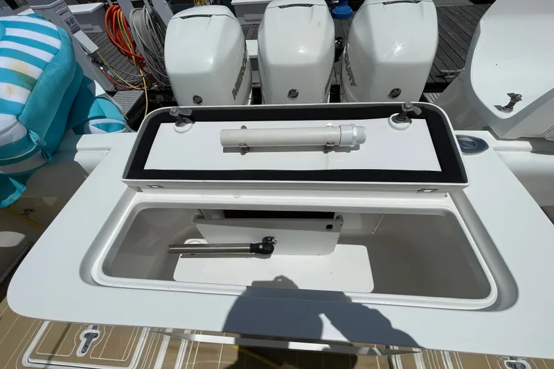 Slide: The Image of 2010 Intrepid 390 Sport Yacht with open storage compartment and triple Mercury outboard engines. - 20