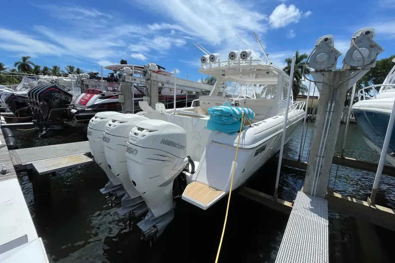Slide: The Image of 2010 Intrepid 390 Sport Yacht docked with triple Mercury engines. - 42