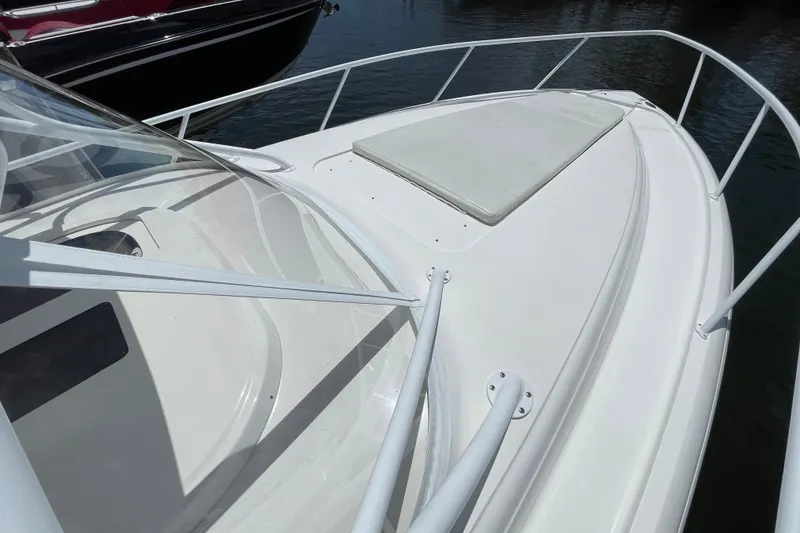 Slide: The Image of 2010 Intrepid 390 Sport Yacht bow view with sleek white deck and railing. - 14