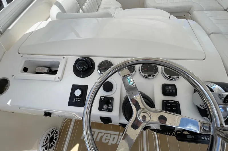Slide: The Image of Steering console of a 2010 Intrepid 390 Sport Yacht with gauges and controls. - 32