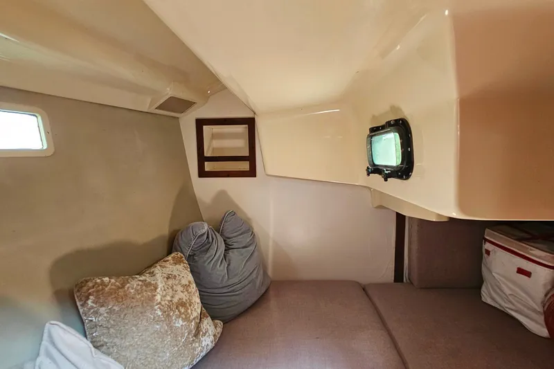 Slide: The Image of Cozy cabin interior of 1989 Hunter 30 sailboat with cushions and porthole. - 13