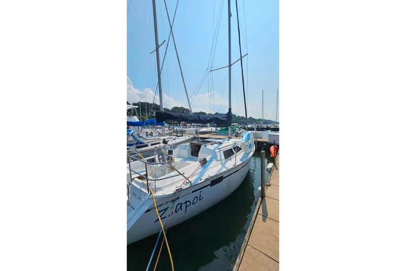 Slide: The Image of 1989 Hunter 30 sailboat docked at marina under clear blue sky. - 8