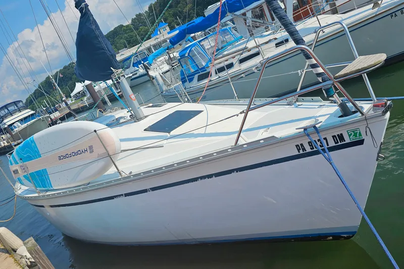 Slide: The Image of 1989 Hunter 30 sailboat docked at marina with paddleboard on deck. - 5