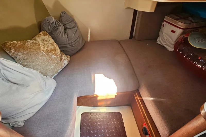 Slide: The Image of Cozy interior of a 1989 Hunter 30 sailboat with cushions and storage. - 14