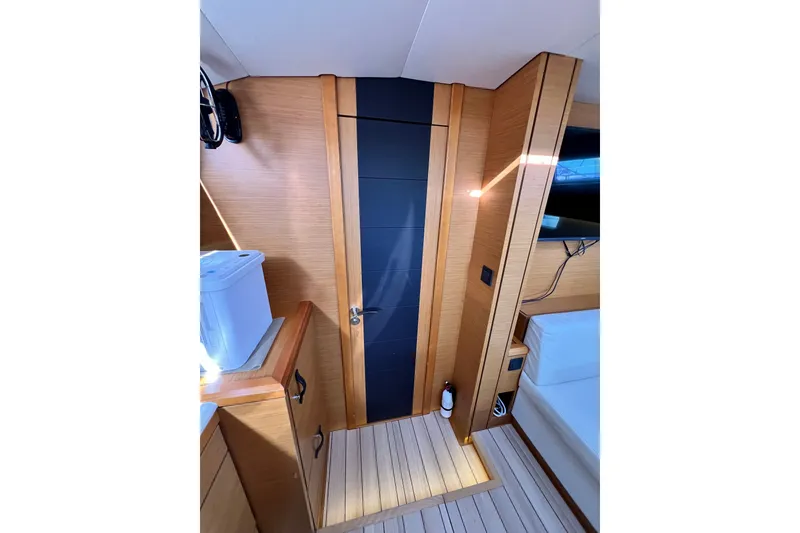Slide: The Image of Interior of 2018 Jeanneau 54 yacht with modern wood paneling and sleek design. - 70