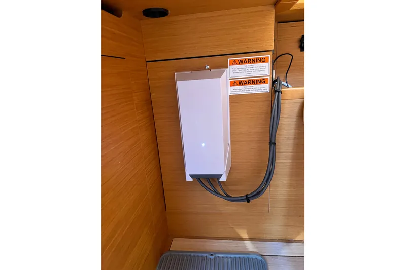 Slide: The Image of Electrical panel with warning labels on a 2018 Jeanneau 54 yacht interior. - 66