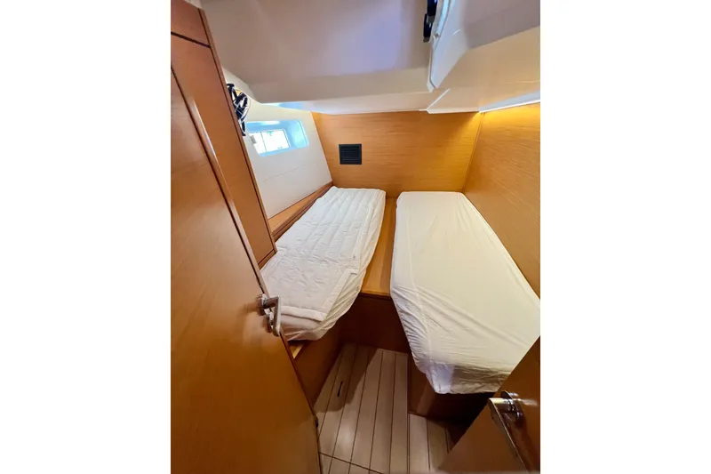 Slide: The Image of Interior cabin of 2018 Jeanneau 54 yacht with twin beds and wooden finish. - 83