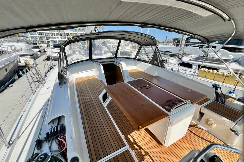 Slide: The Image of Spacious cockpit of a 2018 Jeanneau 54 yacht with wooden flooring and seating area. - 30
