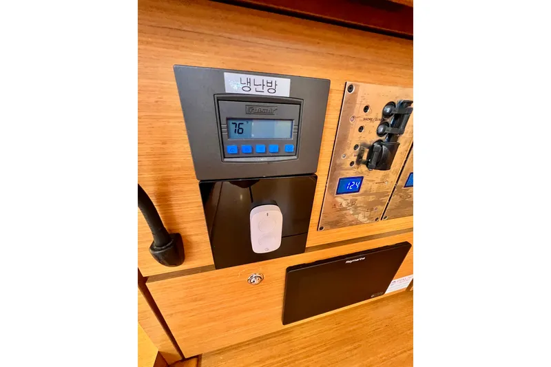 Slide: The Image of Control panel on 2018 Jeanneau 54 yacht, displaying temperature and electrical settings. - 61